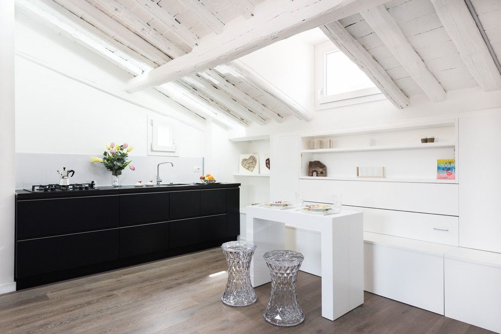 Inspiration for a small contemporary open plan dining in Rome with white walls and light hardwood floors.