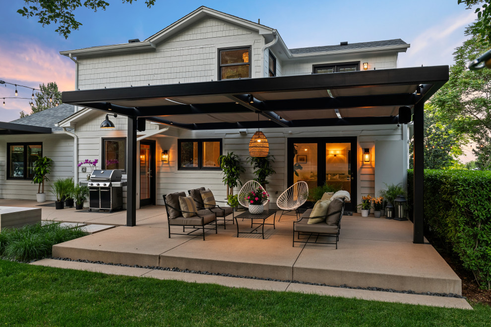Country concrete patio photo in Denver with a gazebo