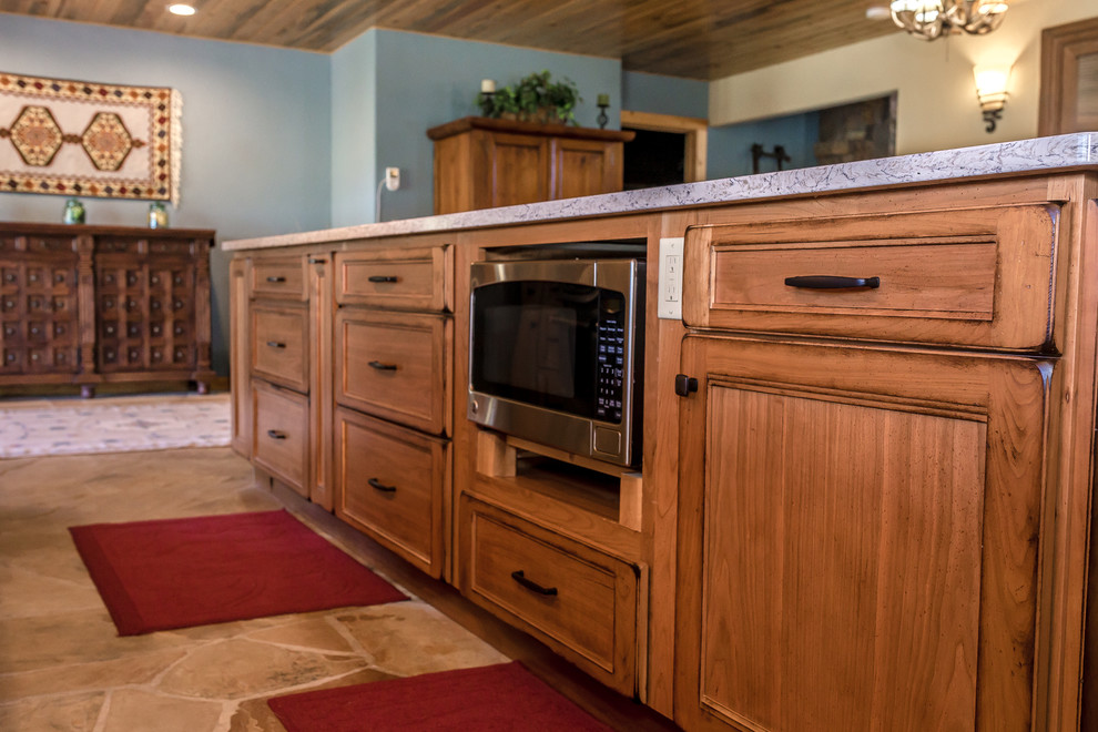 Mid-sized mountain style l-shaped beige floor enclosed kitchen photo in Denver with a farmhouse sink, medium tone wood cabinets, granite countertops, white backsplash, stainless steel appliances, an island and gray countertops