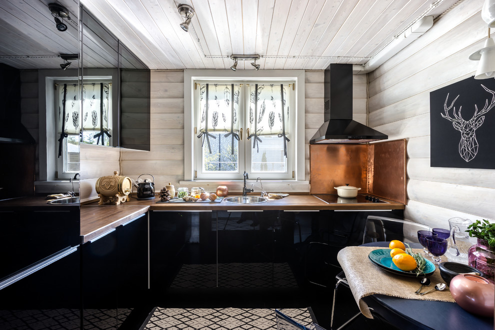 This is an example of a mid-sized country l-shaped separate kitchen in Moscow with a drop-in sink, flat-panel cabinets and black cabinets.