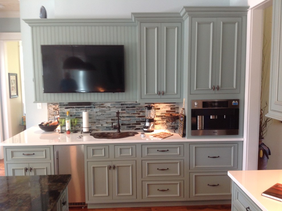 Example of a large transitional u-shaped porcelain tile eat-in kitchen design in Miami with an undermount sink, flat-panel cabinets, green cabinets, quartz countertops, multicolored backsplash, mosaic tile backsplash, stainless steel appliances and an island