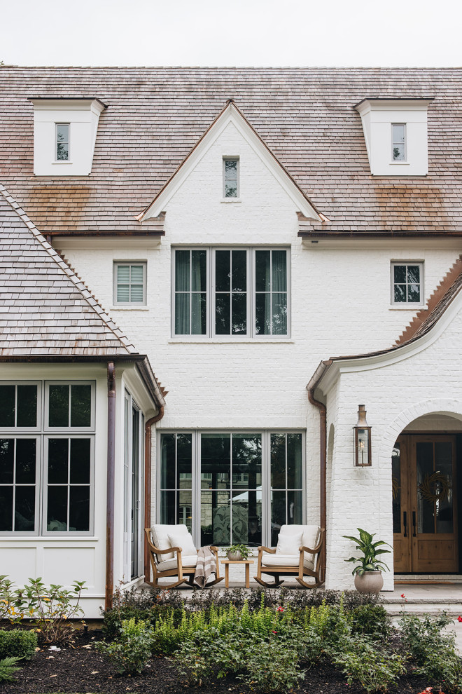 ASC Margaritaville - Large transitional white three-story painted brick house exterior idea in Chicago with a shingle roof and a brown roof