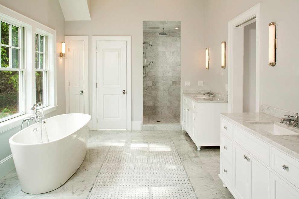Photo of a large transitional master bathroom in Boston with recessed-panel cabinets, white cabinets, a freestanding tub, an alcove shower, white tile, marble, beige walls, marble floors, an undermount sink, marble benchtops, white floor and an open shower.