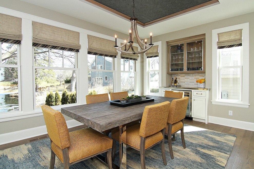 Transitional dining room in Minneapolis with beige walls and medium hardwood floors.