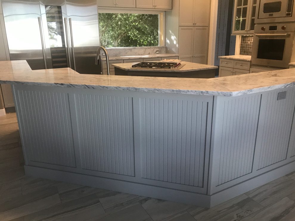 Inspiration for a large transitional eat-in kitchen remodel in Miami with flat-panel cabinets, gray cabinets, marble countertops, gray backsplash, stainless steel appliances, two islands and gray countertops