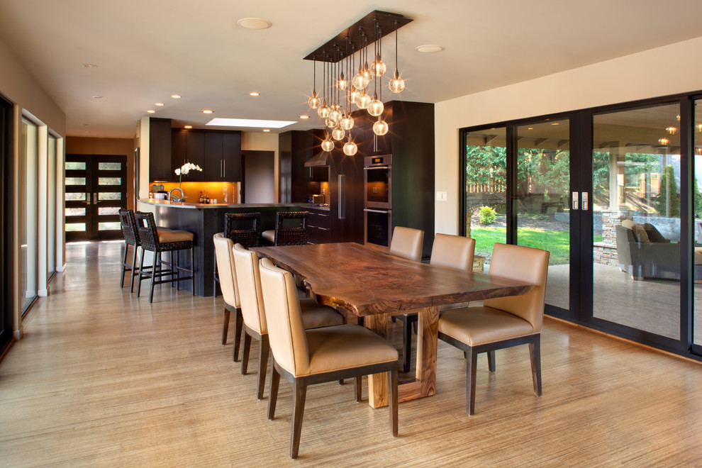 Design ideas for a contemporary kitchen/dining combo in Portland with beige walls and light hardwood floors.
