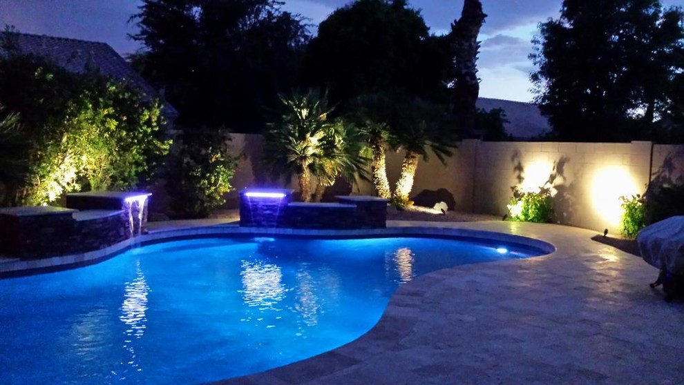 Inspiration for a mid-sized timeless backyard tile and custom-shaped lap pool fountain remodel in Phoenix