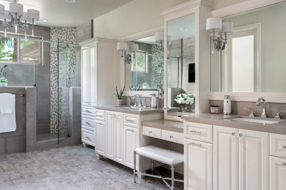 Photo of a large traditional master bathroom in San Diego with raised-panel cabinets, white cabinets, a double shower, a two-piece toilet, multi-coloured tile, ceramic tile, beige walls, mosaic tile floors, an undermount sink, engineered quartz benchtops, multi-coloured floor, a hinged shower door and beige benchtops.