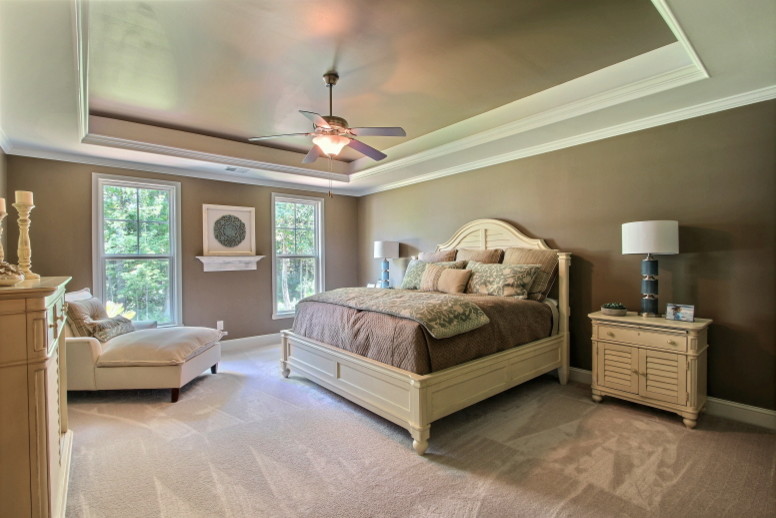 This is an example of a mid-sized transitional master bedroom in Atlanta with beige walls, carpet, no fireplace and beige floor.