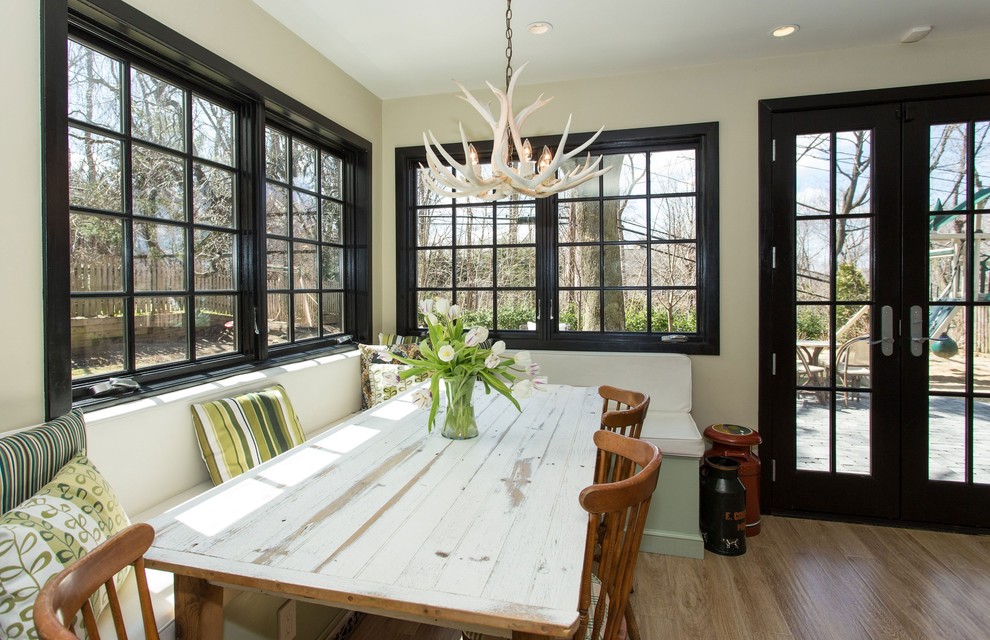 Photo of a contemporary dining room in New York with beige walls and dark hardwood floors.