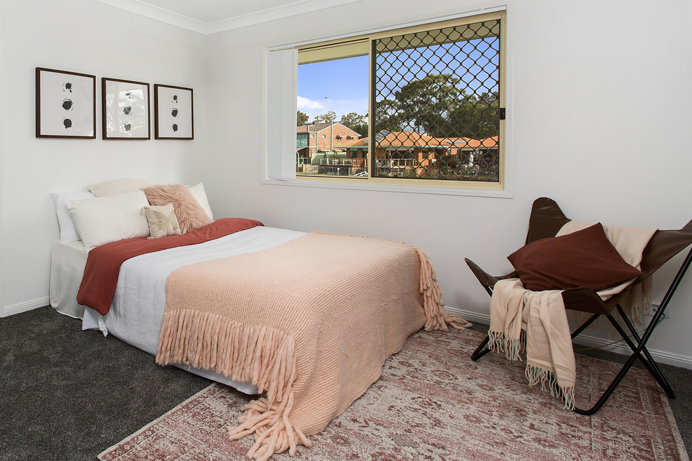 Photo of a beach style guest bedroom in Gold Coast - Tweed with white walls, carpet and grey floor.
