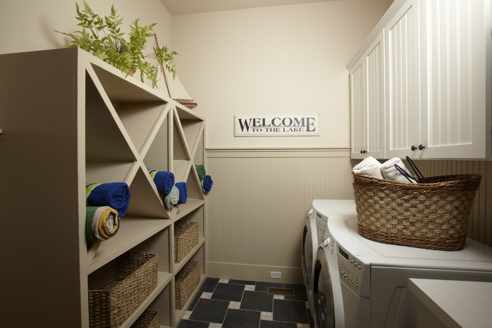 This is an example of a traditional laundry room in Tampa with beige walls.