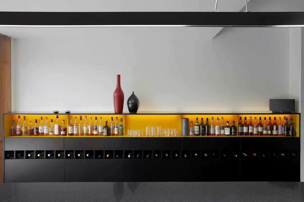 This is an example of a mid-sized contemporary wet bar in London with open cabinets and yellow cabinets.