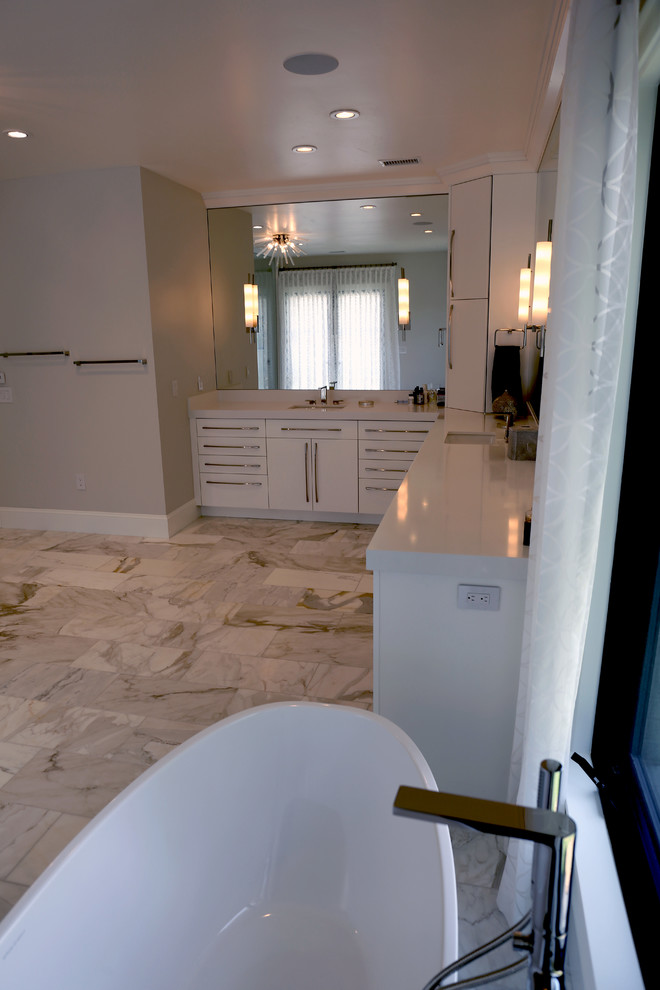 Photo of a large contemporary master bathroom in Denver with flat-panel cabinets, white cabinets, a freestanding tub, a double shower, a two-piece toilet, white tile, cement tile, white walls, an undermount sink, quartzite benchtops, an open shower and white benchtops.