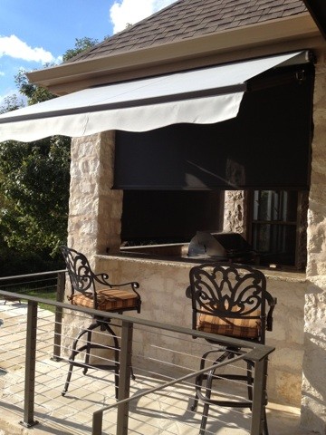 Design ideas for a large contemporary backyard patio in Austin with an awning.