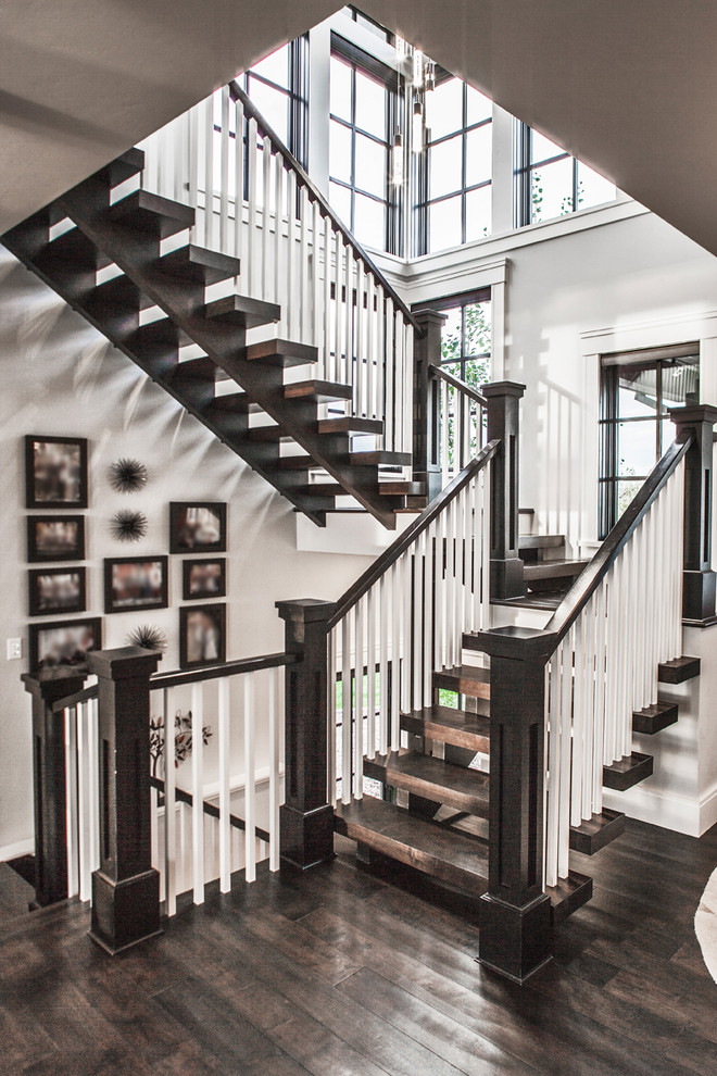 Large transitional wood u-shaped staircase in Denver with open risers.