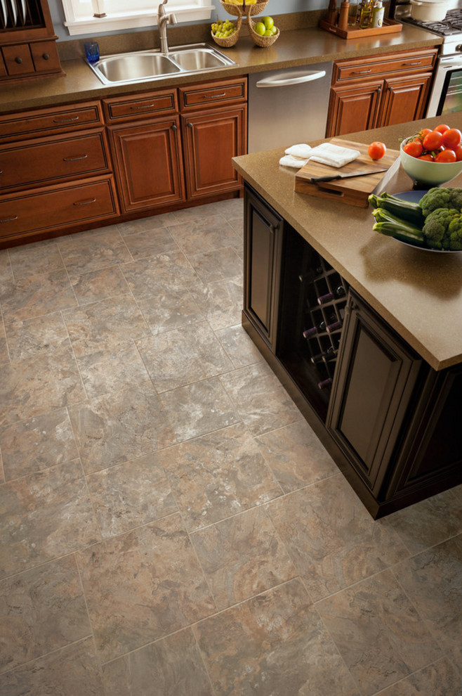 Kitchen - large transitional ceramic tile kitchen idea with a double-bowl sink, raised-panel cabinets, medium tone wood cabinets, laminate countertops, stainless steel appliances and an island