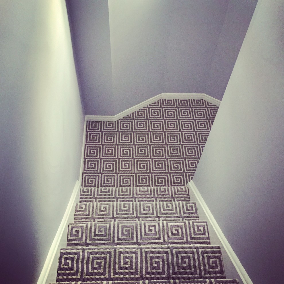 Design ideas for a mid-sized contemporary carpeted u-shaped staircase in Toronto with carpet risers.
