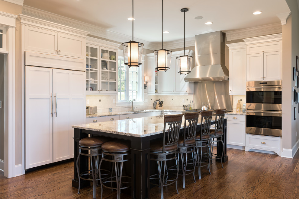 Mid-sized transitional l-shaped dark wood floor and brown floor open concept kitchen photo with an undermount sink, shaker cabinets, white cabinets, granite countertops, stainless steel appliances and an island