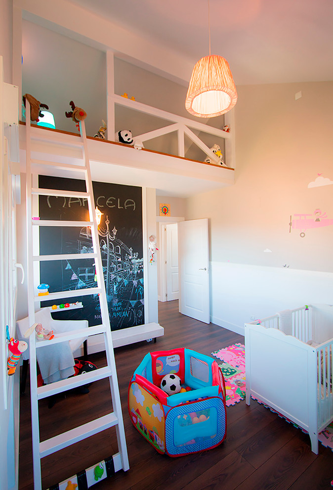 This is an example of a mid-sized modern kids' bedroom for kids 4-10 years old and girls in Other with beige walls and dark hardwood floors.
