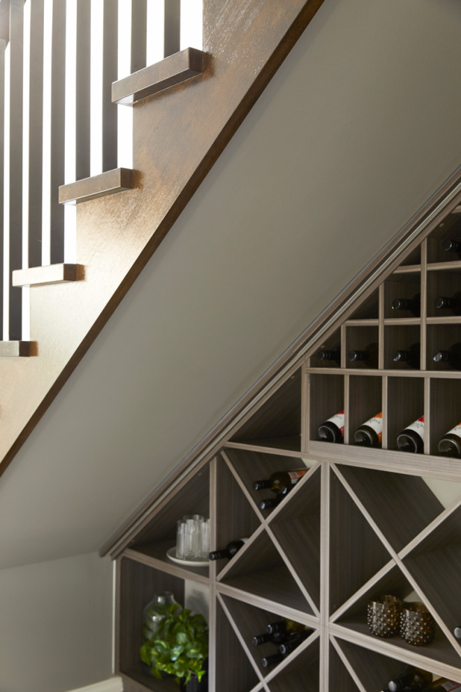 Foto de escalera en L contemporánea de tamaño medio con escalones de madera, contrahuellas de madera y barandilla de madera