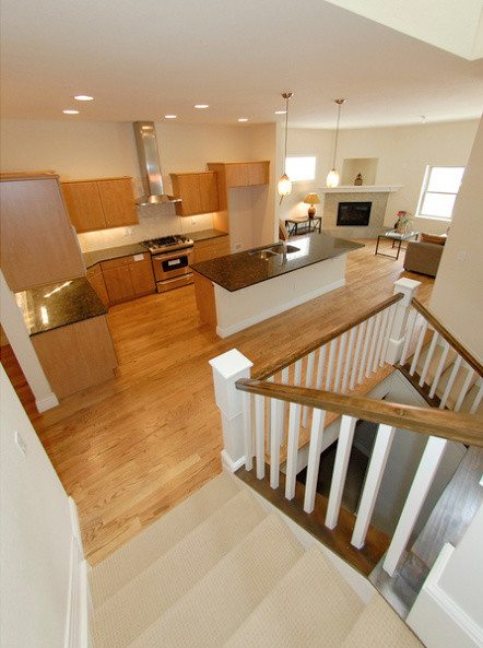 Inspiration for a mid-sized transitional l-shaped light wood floor kitchen remodel in Denver with a double-bowl sink, flat-panel cabinets, light wood cabinets, granite countertops and an island