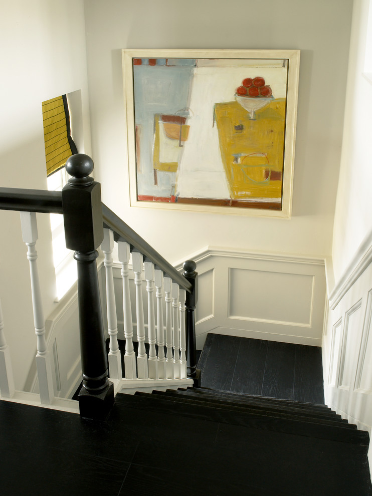 Transitional wood u-shaped staircase in Wiltshire with wood risers.