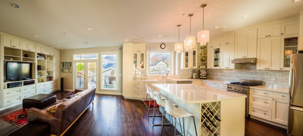 Inspiration for a mid-sized transitional galley dark wood floor kitchen remodel in Vancouver with recessed-panel cabinets, white cabinets, marble countertops, gray backsplash, ceramic backsplash, stainless steel appliances and an island