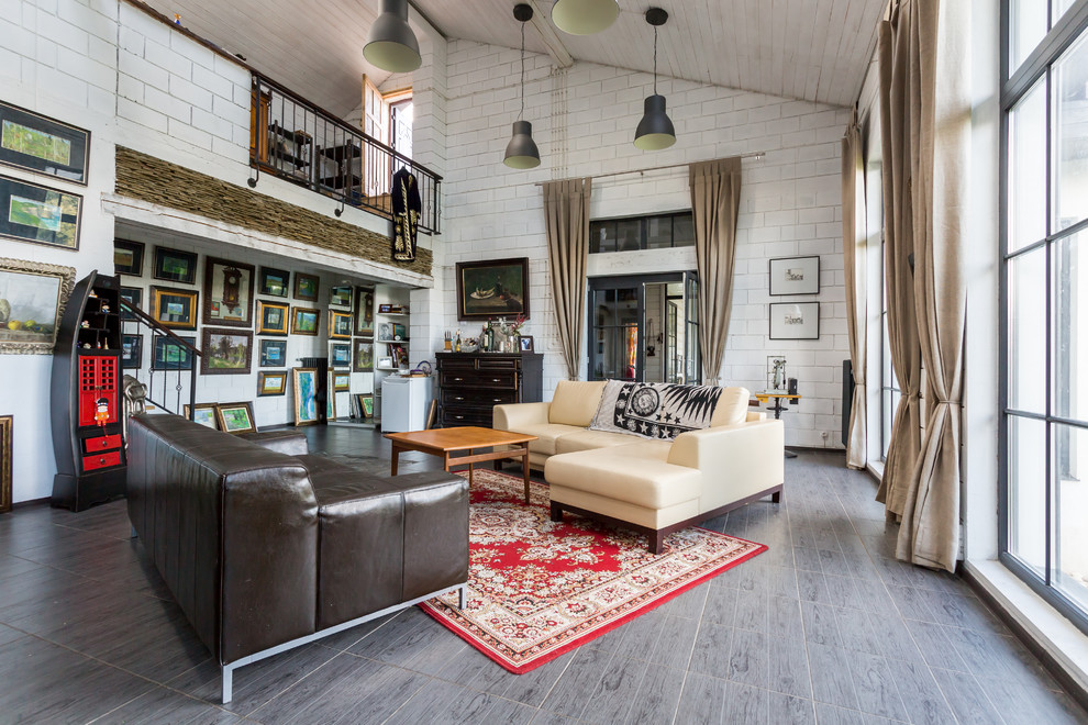Large eclectic open concept living room in Moscow with white walls and no tv.