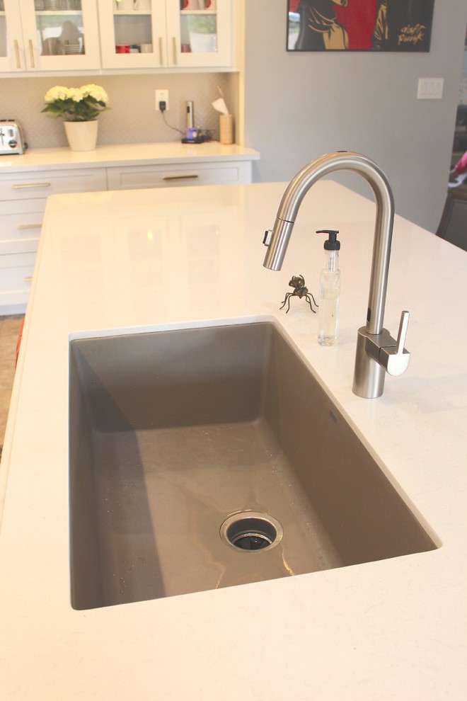Large transitional l-shaped ceramic tile and beige floor open concept kitchen photo in Phoenix with an undermount sink, shaker cabinets, white cabinets, quartzite countertops, gray backsplash, stainless steel appliances and an island