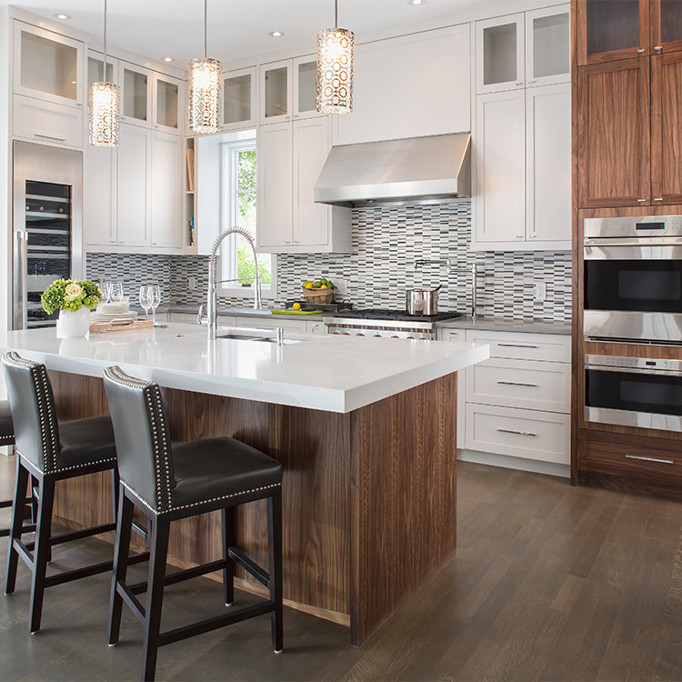 Eat-in kitchen - mid-sized transitional l-shaped dark wood floor eat-in kitchen idea in Toronto with a double-bowl sink, shaker cabinets, white cabinets, solid surface countertops, multicolored backsplash, mosaic tile backsplash, stainless steel appliances and an island