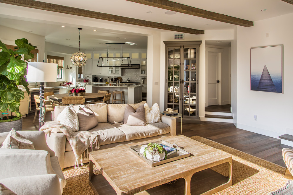 Beach style open concept medium tone wood floor and brown floor family room photo in Los Angeles with white walls and a wall-mounted tv