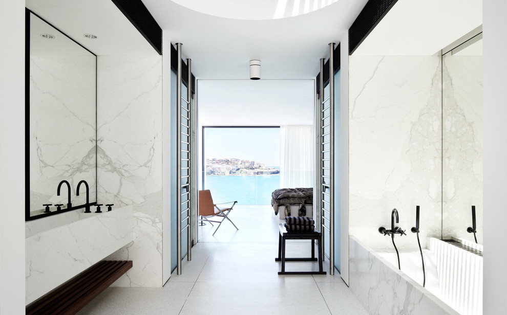 Design ideas for a large modern master bathroom in Sydney with a trough sink, an alcove tub, white tile, white walls and marble.