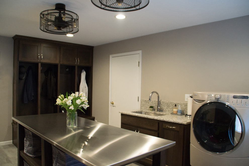 Transitional gray floor utility room photo with an utility sink, recessed-panel cabinets, granite countertops, gray walls and a side-by-side washer/dryer