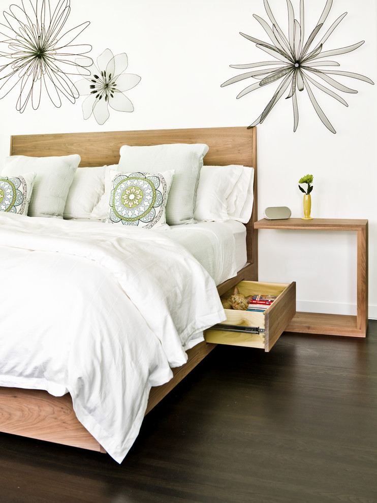 Design ideas for a contemporary bedroom in Chicago with white walls and dark hardwood floors.