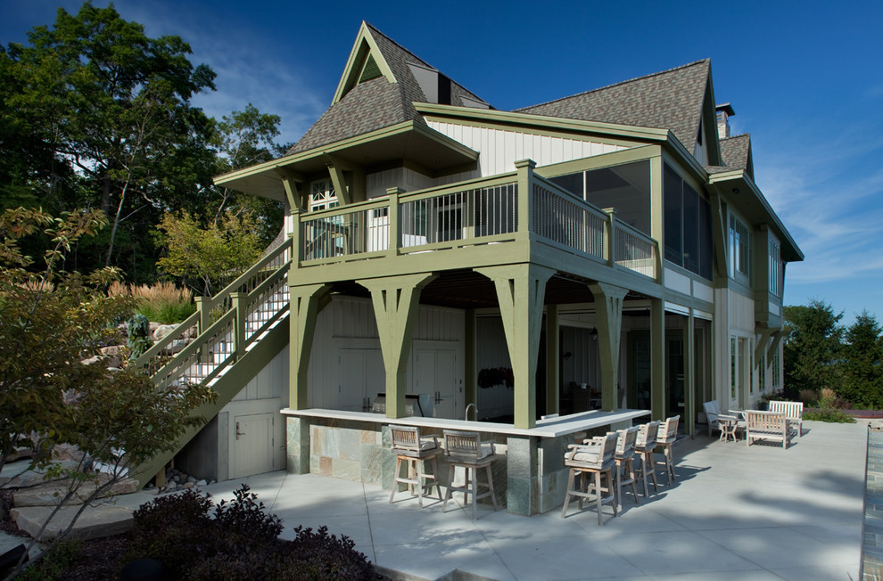 This is an example of a mid-sized beach style two-storey white exterior in Grand Rapids with concrete fiberboard siding.
