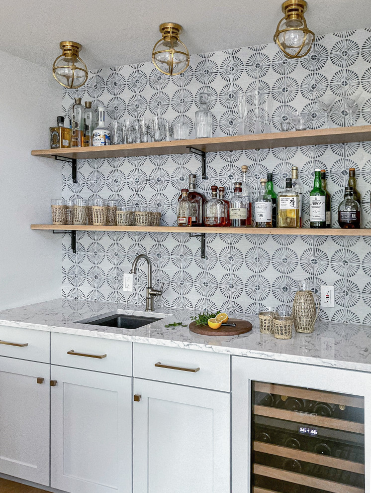 Inspiration for a medium sized beach style single-wall wet bar in Other with a submerged sink, flat-panel cabinets, grey cabinets, engineered stone countertops, blue splashback, terracotta splashback, light hardwood flooring and white worktops.