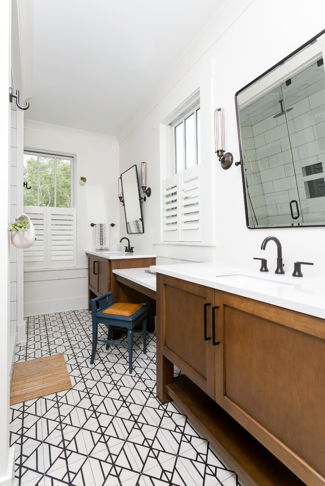 Photo of a mid-sized beach style master bathroom in Charleston with medium wood cabinets, a one-piece toilet, white tile, white walls, ceramic floors, marble benchtops, white floor, white benchtops, shaker cabinets and an undermount sink.