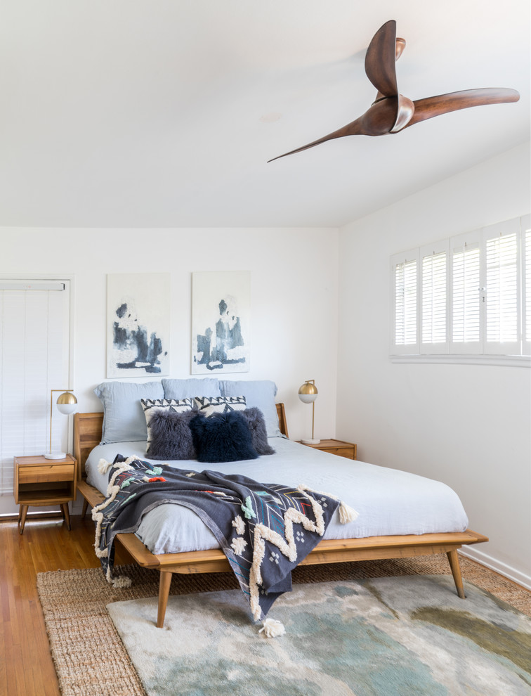 Diseño de dormitorio principal vintage grande con paredes blancas, suelo de madera en tonos medios y suelo marrón