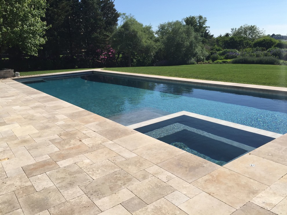Example of a large backyard stone and rectangular lap hot tub design in New York