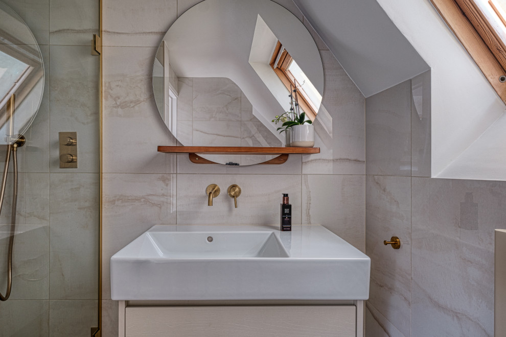 Photo of a small contemporary master bathroom in London with flat-panel cabinets, light wood cabinets, an alcove shower, a wall-mount toilet, beige tile, porcelain tile, beige walls, porcelain floors, an integrated sink, brown floor, an open shower, a single vanity and a floating vanity.