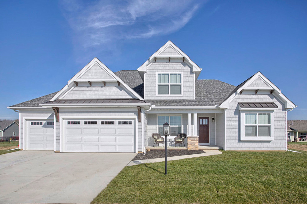 Inspiration for a mid-sized transitional gray two-story vinyl exterior home remodel in Chicago with a hip roof