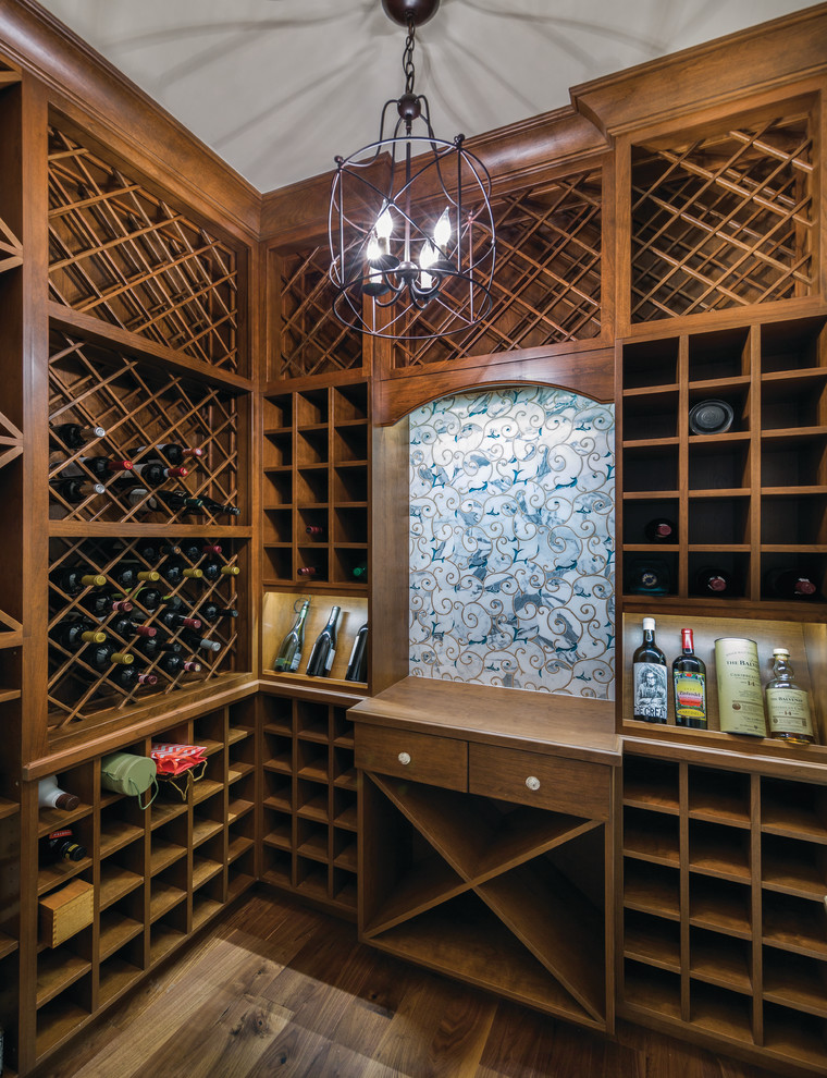 Inspiration for a wine cellar in Miami with light hardwood floors and diamond bins.