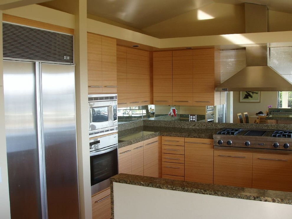 Mid-sized transitional u-shaped kitchen photo in San Francisco with a double-bowl sink, flat-panel cabinets, light wood cabinets, granite countertops, mirror backsplash and stainless steel appliances