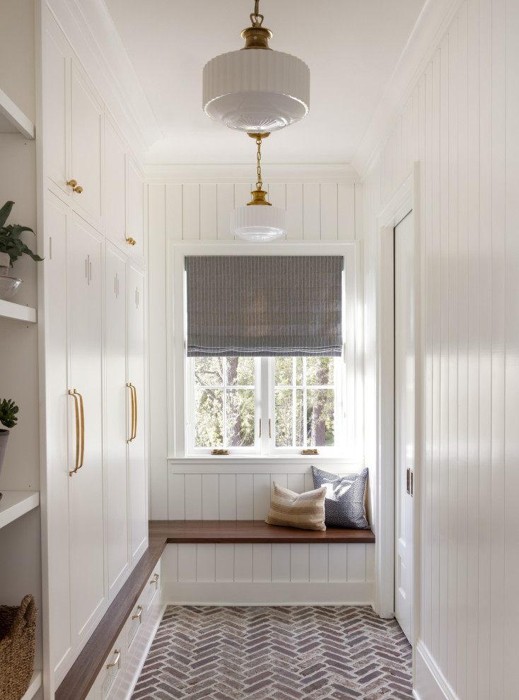 Mid-sized transitional mudroom in DC Metro with white walls, brick floors and multi-coloured floor.