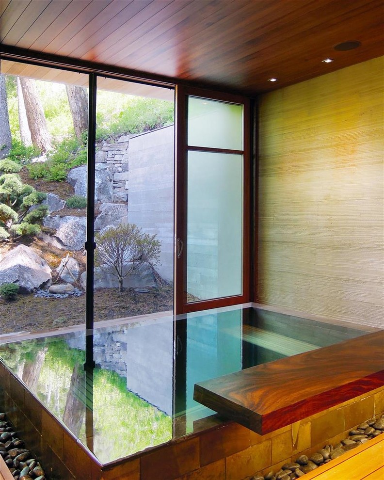 Photo of a contemporary indoor pool in Other with a hot tub.