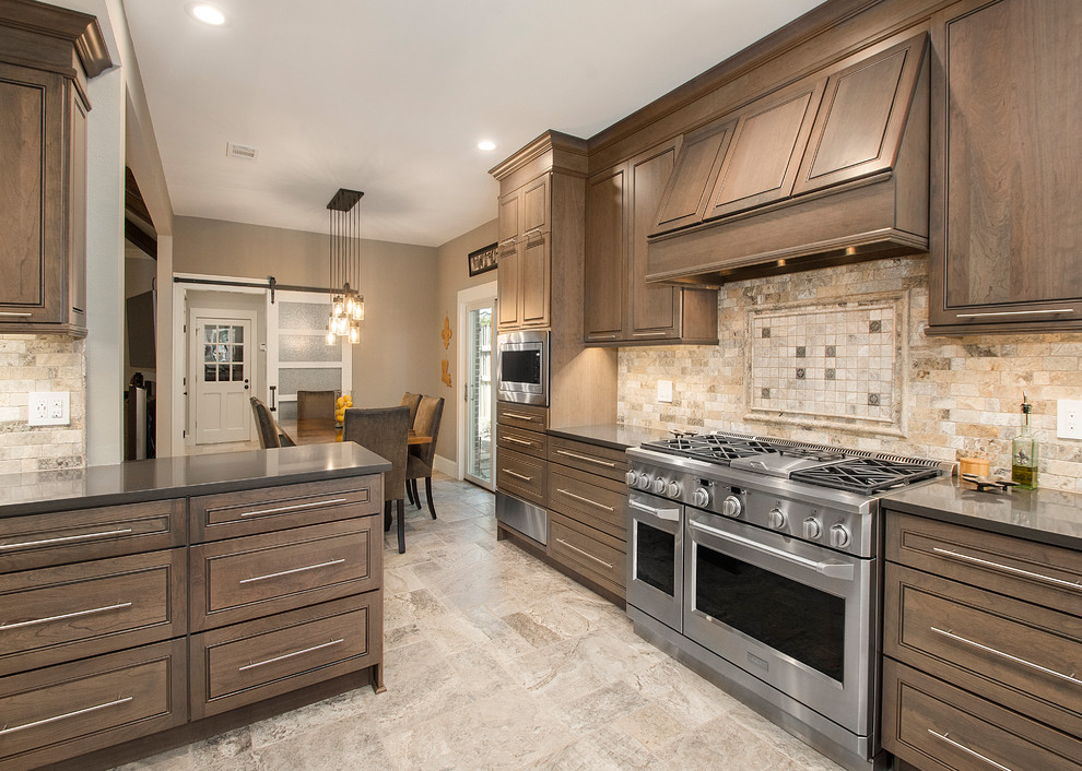 Inspiration for a mid-sized traditional l-shaped kitchen pantry in Dallas with an undermount sink, beaded inset cabinets, quartz benchtops, beige splashback, stainless steel appliances, travertine floors, a peninsula, dark wood cabinets, mosaic tile splashback and beige floor.