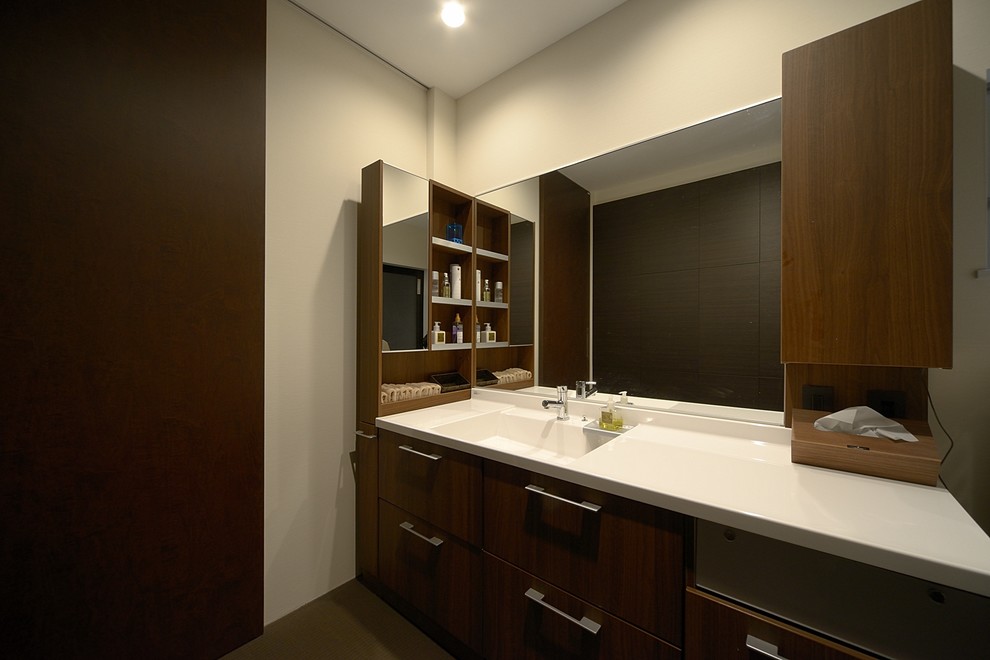 Modern powder room in Other with brown cabinets and a freestanding vanity.
