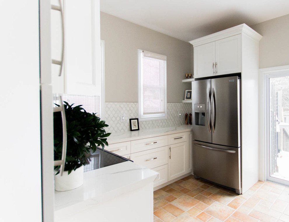 Design ideas for a small transitional u-shaped separate kitchen in Toronto with an undermount sink, shaker cabinets, white cabinets, quartzite benchtops, white splashback, mosaic tile splashback, stainless steel appliances, terra-cotta floors, no island, orange floor and white benchtop.