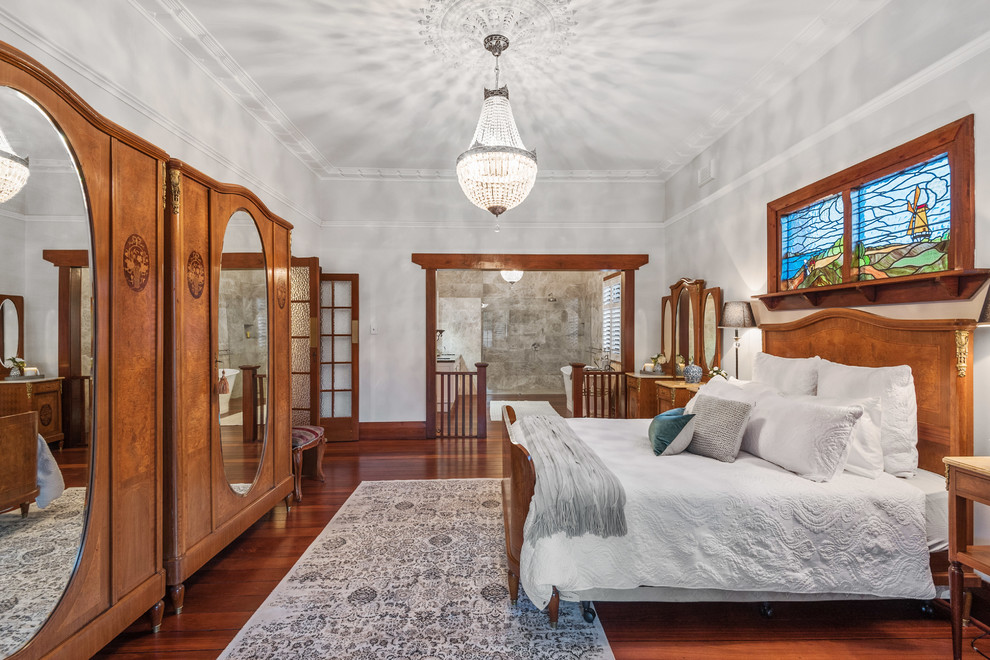 Photo of a large traditional master bedroom in Perth with grey walls, dark hardwood floors, brown floor and no fireplace.